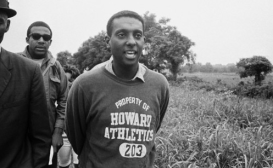 Stokely Carmichael sporting a Howard Athletics sweatshirt.